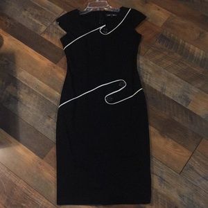Black dress with white piping trim and buttons
